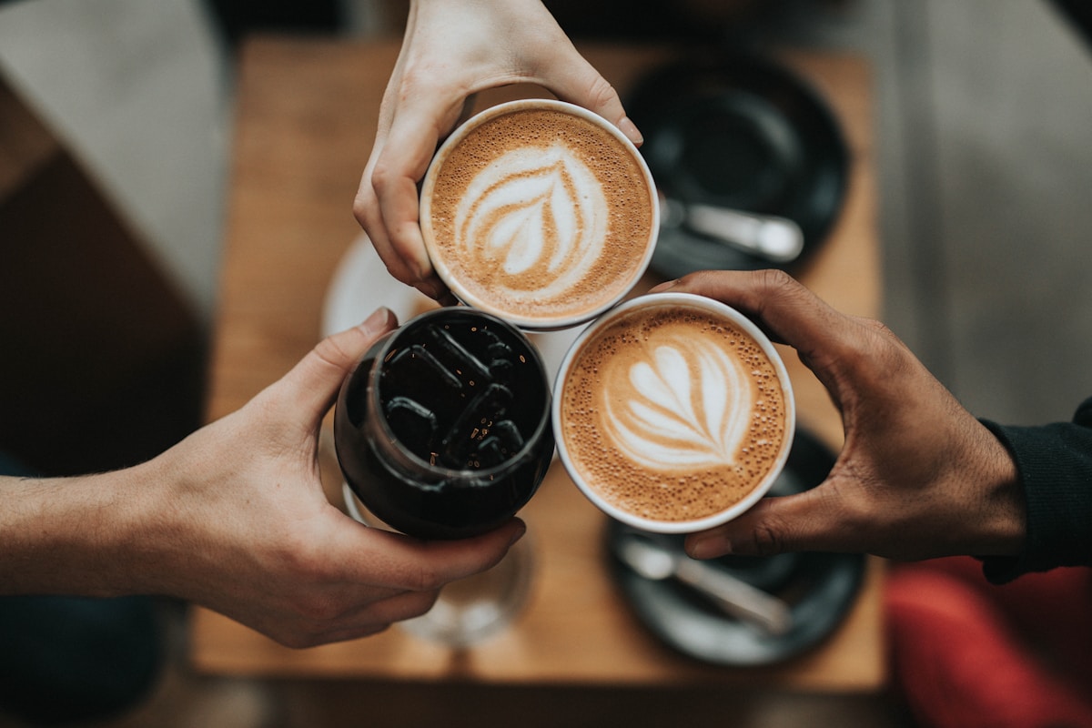 Close view of a kopi cup on a kopitiam table, dark coffee with a thin layer of foam at the rim